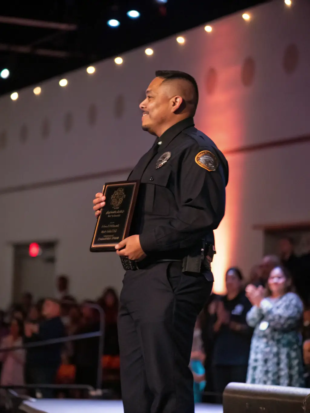 An employee of Solid Security Pro receiving an award for outstanding performance during a company event, highlighting recognition and career advancement opportunities.